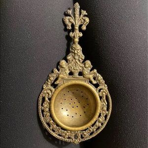 Vintage ornate brass tea strainer